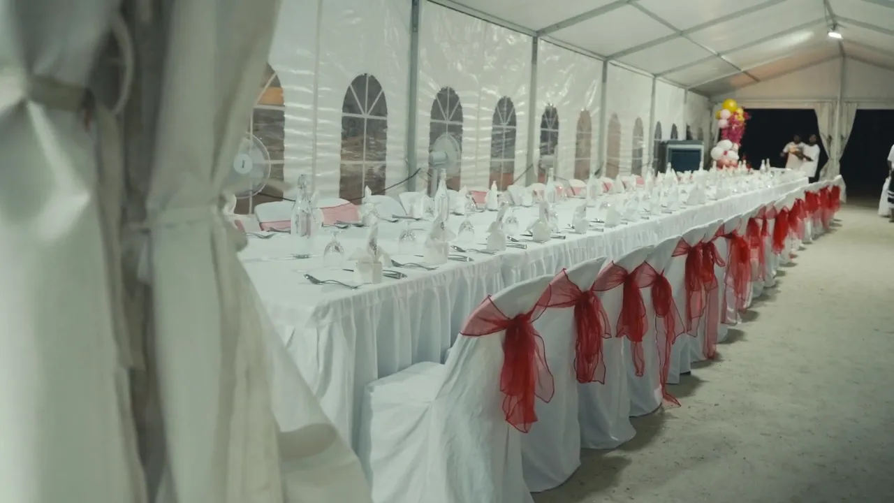 Long banquet tables set inside an event tent on Kamadhoo