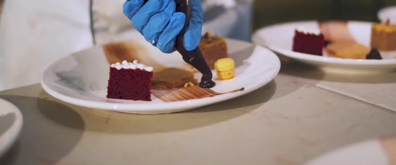 A slice of red velvet cake being plated