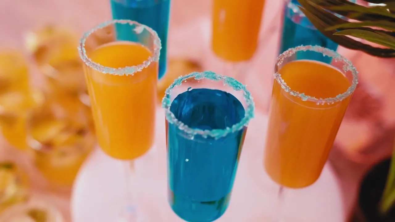 Orange and blue mocktails with sugared rims